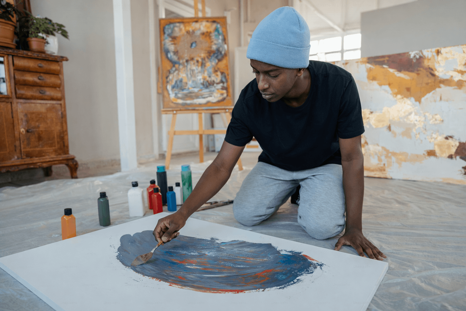 Person painting in an art studio.